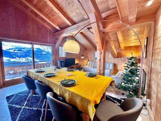 Experience the charm of this stunning chalet, featuring a cozy dining area perfect for gatherings.