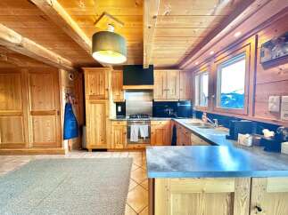 This stunning kitchen boasts a warm, inviting ambiance with its wooden cabinetry and ceiling.