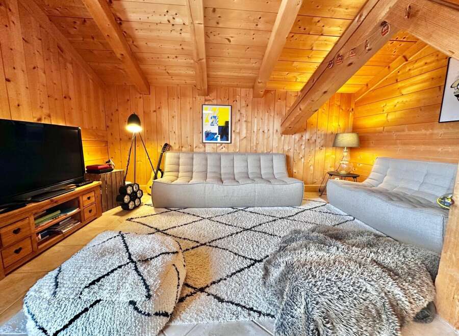 This cozy living space features a warm wooden interior, creating a welcoming atmosphere.