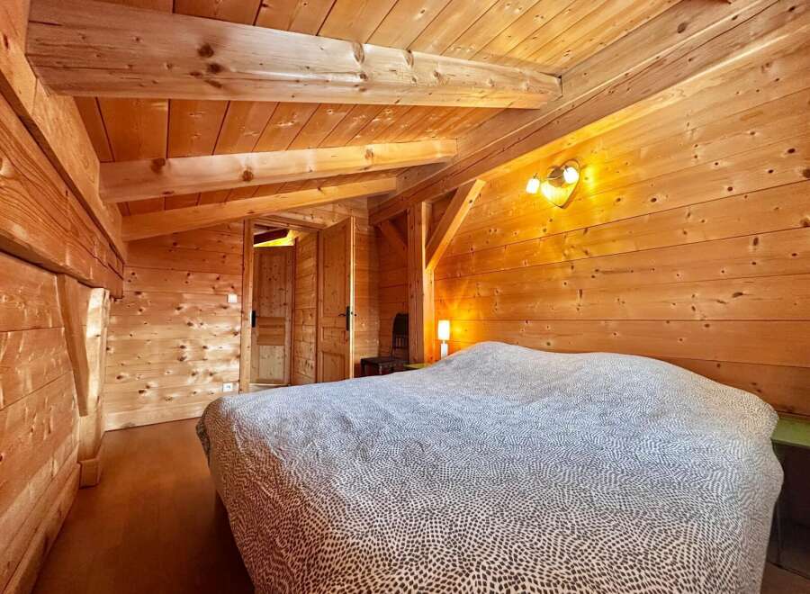 Step into this cozy bedroom featuring stunning wooden accents throughout.