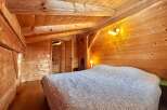 Step into this cozy bedroom featuring stunning wooden accents throughout.