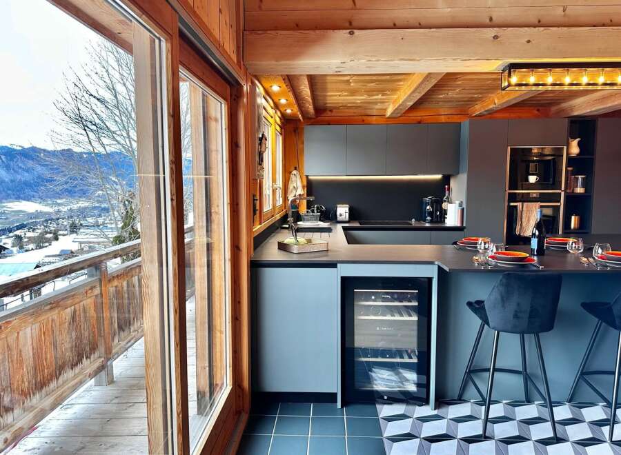 Experience luxury living in this stunning kitchen with breathtaking mountain views.