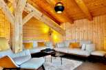 Experience the warmth of this stunning living space, featuring exposed wooden beams and paneling that create a cozy atmosphere.