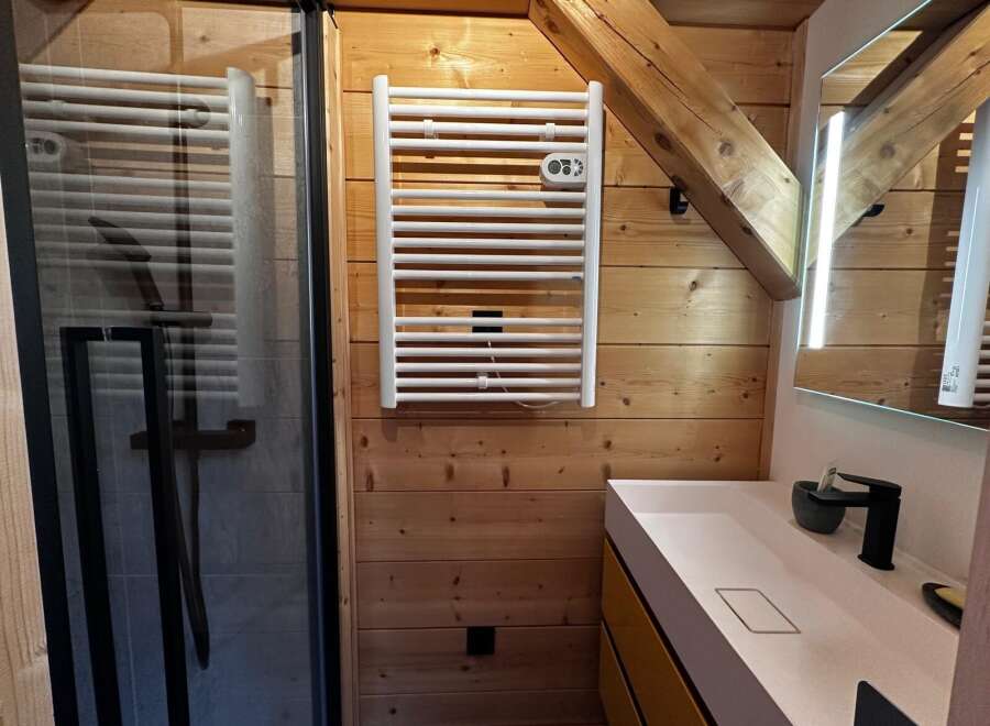 This stunning bathroom boasts a modern design with a touch of rustic charm.