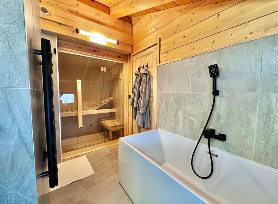 Discover the epitome of relaxation in this luxurious bathroom, featuring a private sauna for ultimate wellness.