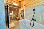 Discover the epitome of relaxation in this luxurious bathroom, featuring a private sauna for ultimate wellness.