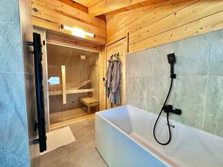 Discover the epitome of relaxation in this luxurious bathroom, featuring a private sauna for ultimate wellness.