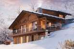 Experience the ultimate winter getaway in this stunning chalet nestled in a snowy landscape.