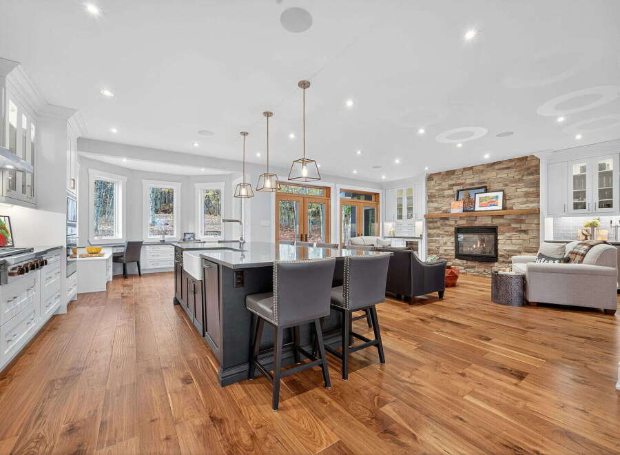 Step into luxury with this stunning kitchen and living space! Featuring a spacious island with seating, perfect for entertaining, and a cozy fireplace, this home offers both style and comfort.