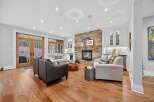 Step into luxury with this stunning living room, featuring a cozy fireplace and elegant hardwood floors.