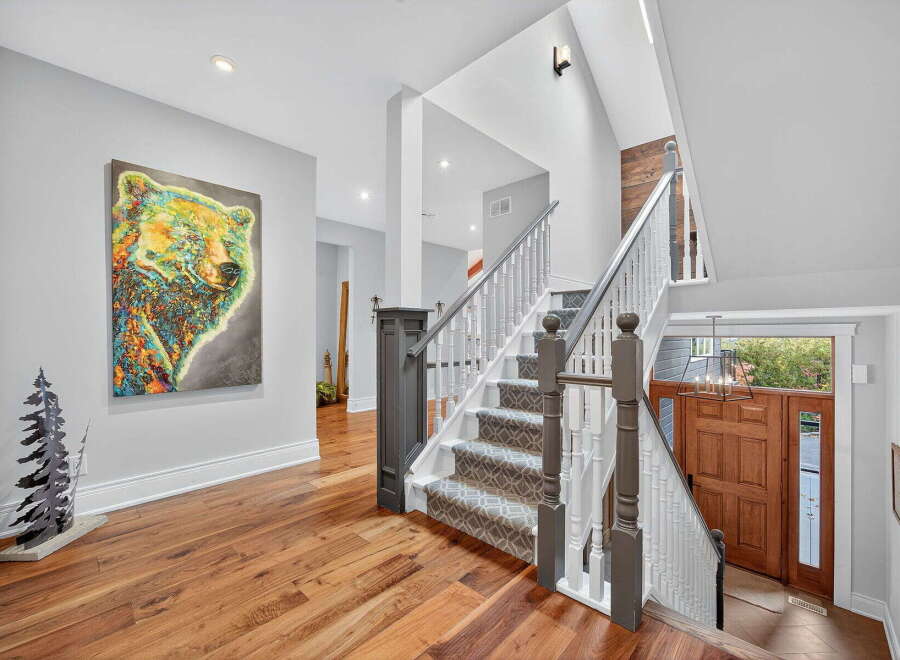 Step into luxury with this stunning property featuring a grand staircase and exquisite hardwood floors.