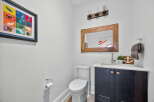 This stylish powder room features a modern vanity with a sleek countertop and dark cabinetry.