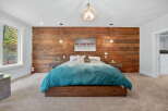 This stunning bedroom features a rustic wood accent wall, creating a warm and inviting atmosphere.