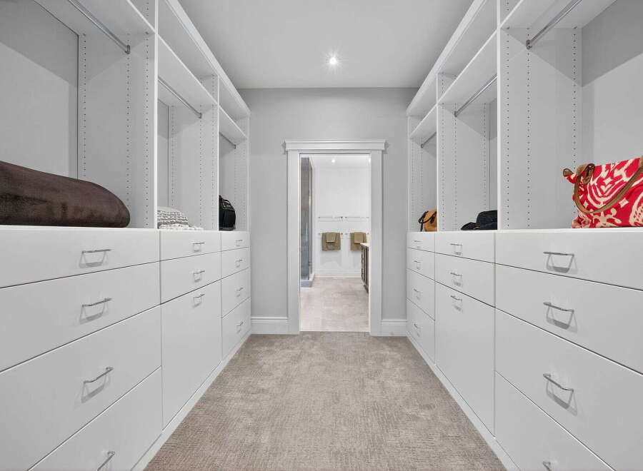 Step into luxury with this stunning walk-in closet, designed for both style and functionality.