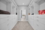 Step into luxury with this stunning walk-in closet, designed for both style and functionality.
