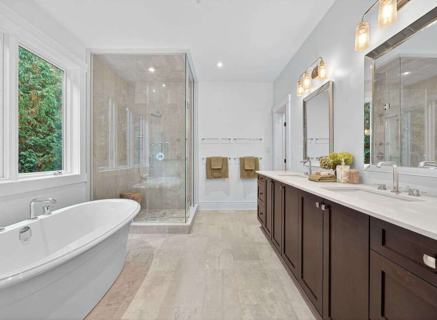 Step into luxury with this stunning bathroom! Featuring a sleek, modern design, this space boasts a spacious walk-in shower, a relaxing soaking tub, and elegant double vanities.