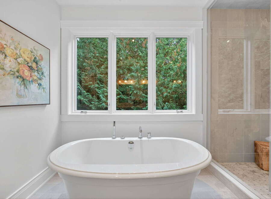 This luxurious bathroom features a stunning freestanding tub, perfect for a relaxing soak.
