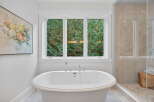 This luxurious bathroom features a stunning freestanding tub, perfect for a relaxing soak.