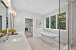 Step into luxury with this stunning bathroom, featuring a freestanding tub and a spacious walk-in shower.