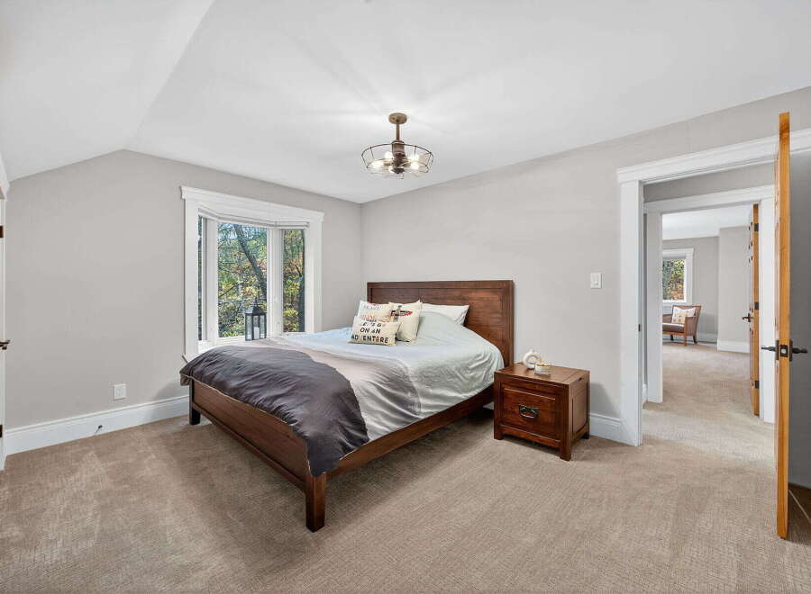This inviting bedroom features a cozy atmosphere with a comfortable bed and a stylish nightstand.