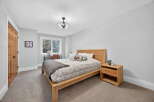 This inviting bedroom showcases a modern design with a touch of warmth.