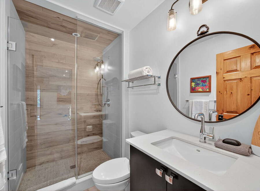 Step into luxury with this beautifully designed bathroom! Featuring a modern glass shower, elegant vanity, and stylish lighting, this space offers both functionality and sophistication.