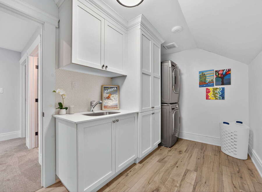 This stunning laundry room boasts a sleek and modern design, perfect for any home.