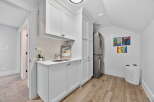 This stunning laundry room boasts a sleek and modern design, perfect for any home.