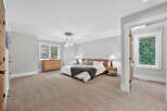This spacious bedroom offers a serene retreat with its neutral color palette and ample natural light.