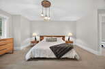 This inviting bedroom boasts a cozy ambiance with its neutral color palette and plush carpeting.