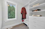 Step into this beautifully organized closet, featuring ample storage and a stylish design.