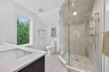 Step into luxury with this beautifully designed bathroom! Featuring a modern glass shower, sleek countertops, and a bright, airy atmosphere, this space is perfect for relaxation.