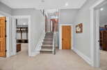 Step into this inviting entryway, showcasing a beautiful staircase and stylish flooring.
