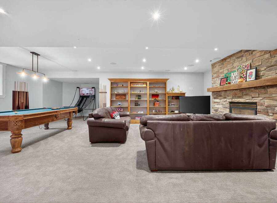 This stunning property boasts a spacious game room, perfect for entertaining and relaxation.