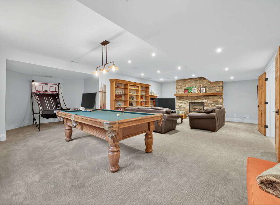 This stunning property boasts a spacious game room, perfect for entertaining and relaxation.