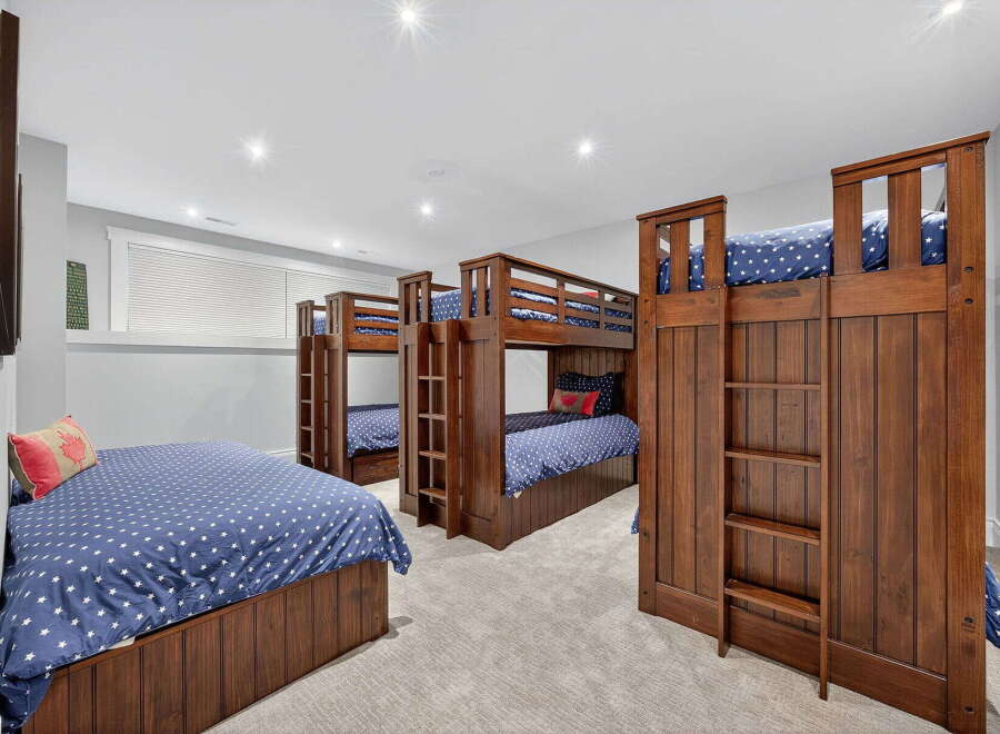 This stunning bedroom boasts multiple bunk beds, perfect for accommodating a large family or hosting guests.