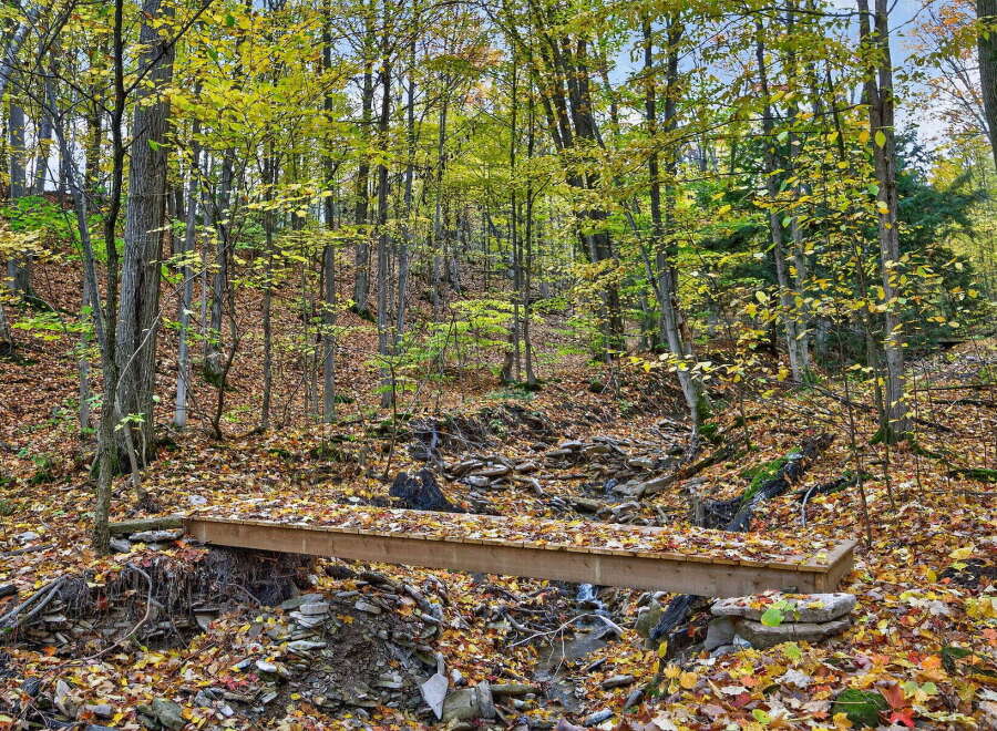 Discover the tranquility of this stunning property nestled in a lush, wooded area.