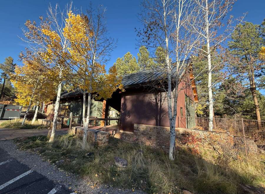 Nestled amidst the vibrant hues of autumn, this charming property boasts a unique blend of rustic architecture and natural beauty.