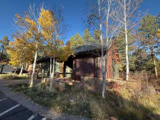 Nestled amidst the vibrant hues of autumn, this charming property boasts a unique blend of rustic architecture and natural beauty.