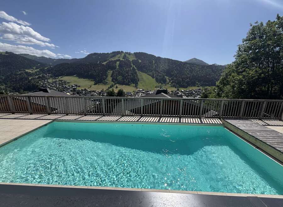 Experience breathtaking mountain views from this stunning property featuring a crystal-clear swimming pool.