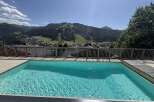 Experience breathtaking mountain views from this stunning property featuring a crystal-clear swimming pool.