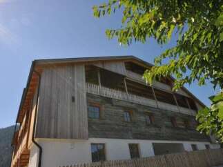 Discover a charming wooden house nestled in a serene environment.
