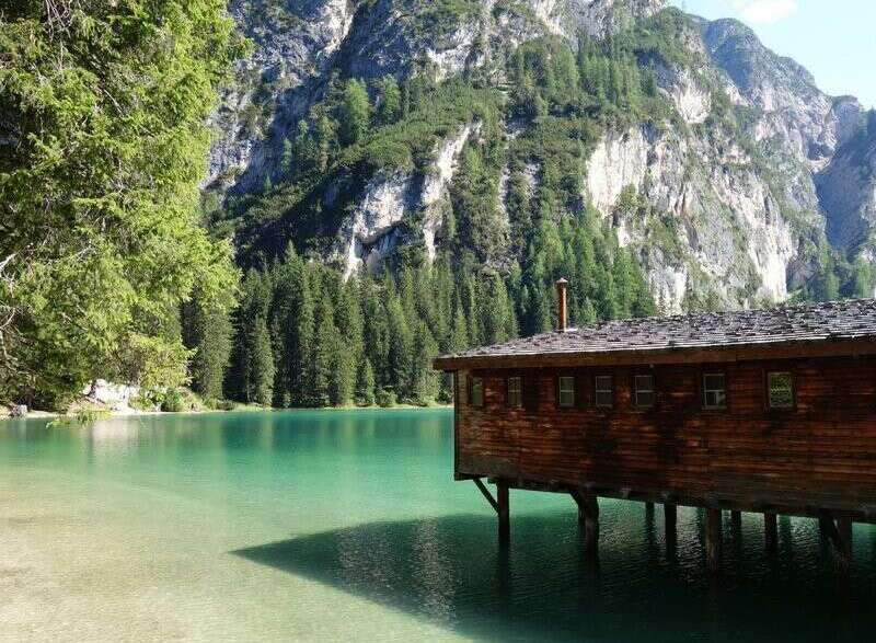 Nestled on the serene shores of a pristine lake, this charming wooden cabin offers a unique blend of rustic charm and natural beauty.