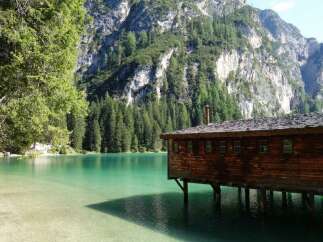Nestled on the serene shores of a pristine lake, this charming wooden cabin offers a unique blend of rustic charm and natural beauty.