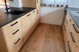 This stunning kitchen features custom cabinetry with a natural wood finish, creating a warm and inviting atmosphere.