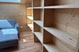 This stunning property boasts a custom-built wooden shelving unit, perfect for displaying your favorite books and decor.