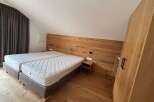 Discover the charm of this inviting bedroom, featuring a cozy double bed and a stylish wooden headboard.