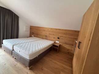 Discover the charm of this inviting bedroom, featuring a cozy double bed and a stylish wooden headboard.