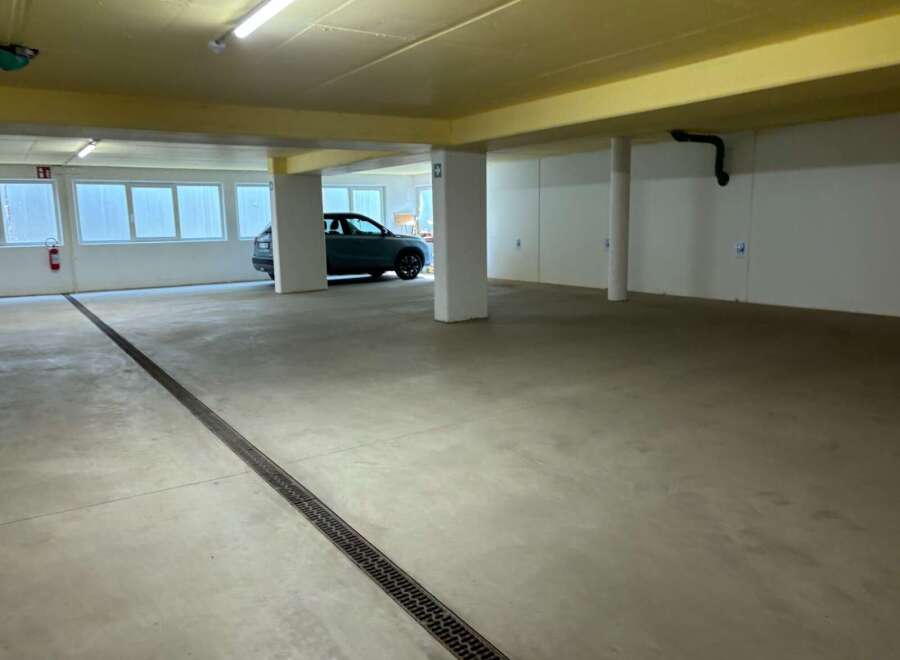 Discover this spacious and well-lit parking garage, perfect for secure vehicle storage.