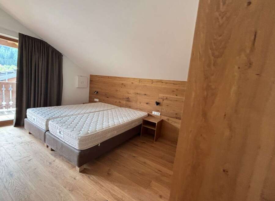 This cozy bedroom features a comfortable double bed with a wooden headboard, perfect for a relaxing stay.